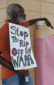 A protester signals his dissatisfaction with WAPA during a PSC meeting in August. (Source file photo by Bethaney Lee)