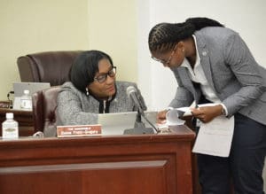 Sens. Donna Frett-Gregory, left, and Janelle Sarauw consult during Monday's Senate Session. (Photo by Barry Leerdam for the V.I. Legislature)