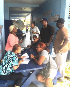 Volunteers take information from shelter applicants on Sept. 8, 2017, at the Sprauve School. (Source photo by Amy Roberts)