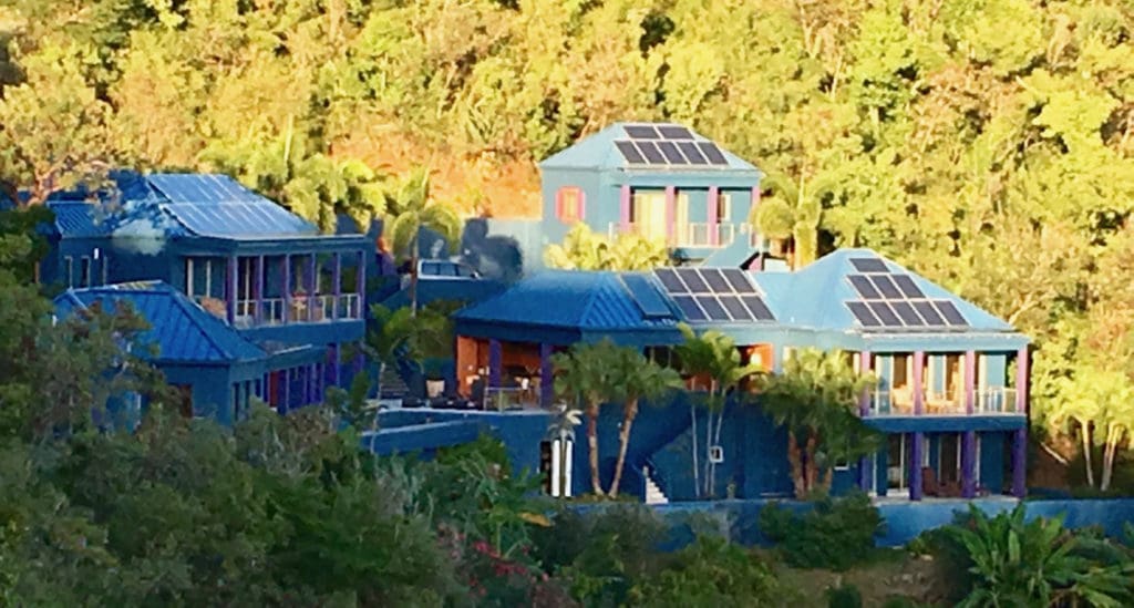 Solar panels cover the roof of a St. John hillside home.