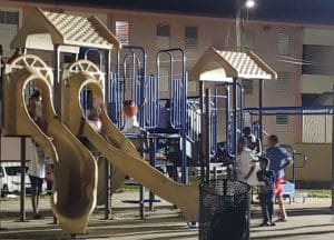 Children find solace in play at vigil. (Source photo by Shaun Pennington)