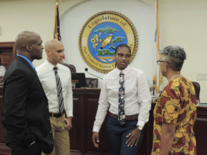 The three nominees for the Cannabis Advisory Board talk with Sen. Janelle Sarauw during the Rules and Judiciary meeting Friday. From left, Miguel Tricoche, Hugo Roller II, Catherine Keen. (Photo by Barry Leerdam for the USVI Legislature)