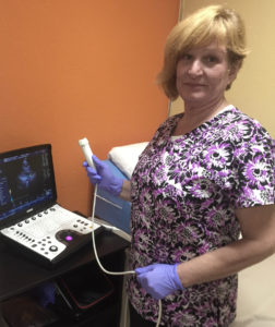 Echo technician Georgia Moorman shows off her new portable echocardiogram equipment. (Source photo by Susan Ellis)