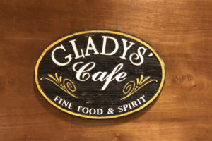 A vintage sign, salvaged from the embers of the devastating blaze the razed the old restaurant, adorns the wall at Gladys’ Cafe. (Source photos by Teddi Davis)