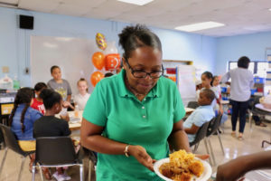 A plate of homemade food was one of the treats of the celebration. O’Reilly-Bates fills her plate, ready to enjoy the special lunch in her honor. (Source photo by Linda Morland)
