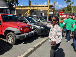Edithrose Jennings points to a sidewalk blocked by parked cars. (Source photo by Amy Roberts)