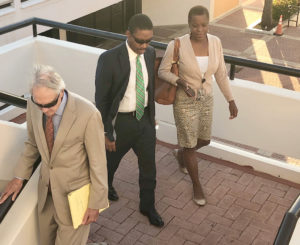 Defendant Amos Carty Jr. leaves Superior Court Thursday, accompanied by his wife, Verna and Attorney Gordon Rhea. (Source photo by Judi Shimel)