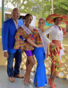 Lt. Gov. Tregenza Roach introduces the Miss St. Croix contests, from left, Allayeah John-Baptiste, Izhani Rosa and Tatyana Massiah. (Source photo by Denise Lenhardt-Benoit)