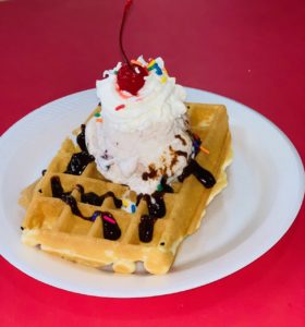 A Belgian waffle topped with ice cream is the newest addition to the menu at Cafe de la Creme.