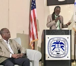 Valdemar Hill listens to Agriculture Commissioner Positive T. A. Nelson at Friday’s cannabis forum. (Source photo by Susan Ellis)