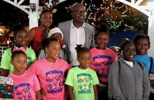 Sumayah Bryan, left, and Gov. Albert Bryan Jr. celebrate with members of the “Dynamic Dancers,” who performed during Friday’s holiday party. (Source photo by James Gardner)