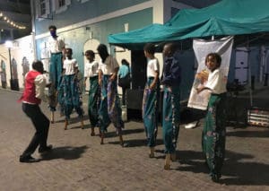 Clinton Stapleton, on sax, accompanied the Essentric moko jumbie troupe as they performed Friday. (Source photo by James Gardner)
