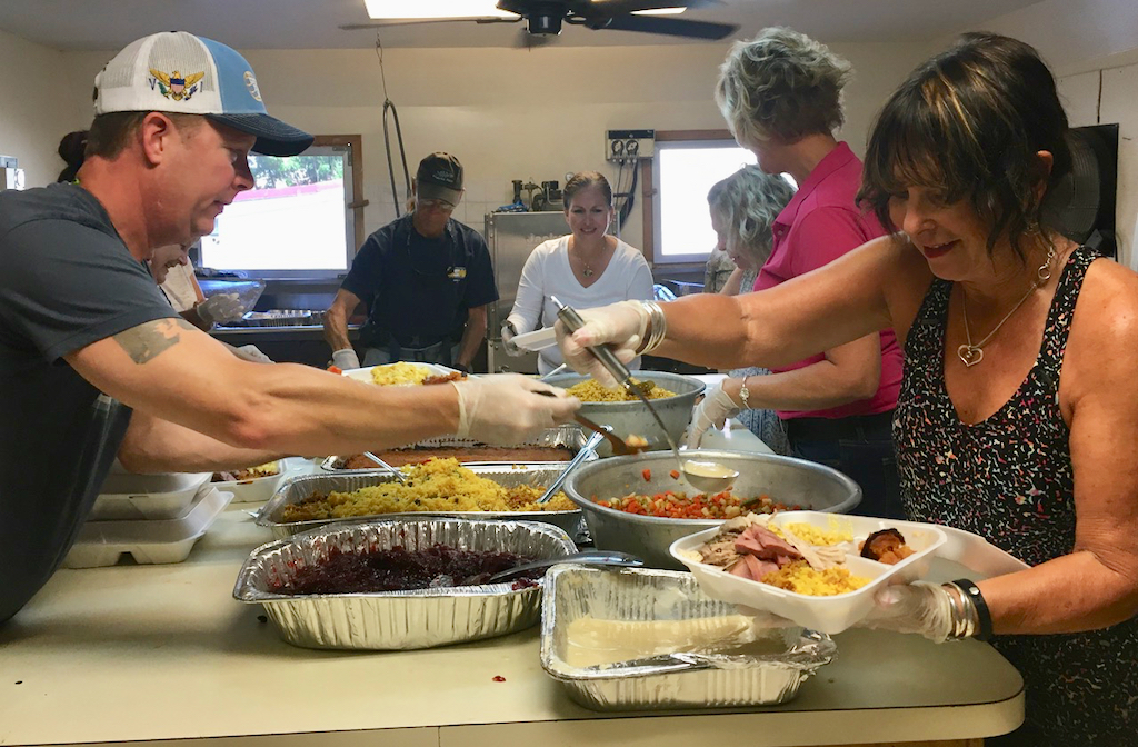 Volunteers crowd into the St. Mary’s kitchen to assemble Thanksgiving dinner plates. (Source photo by Susan Ellis)