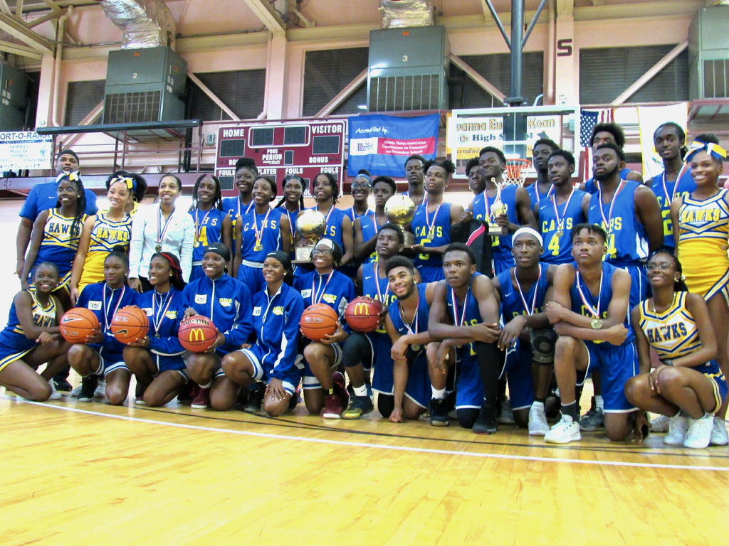 The girls and boys basketball teams celebrate winning both halves of the IAA/McDonald’s Martin Luther King Memorial Invitational Boys and Girls Basketball Tournament