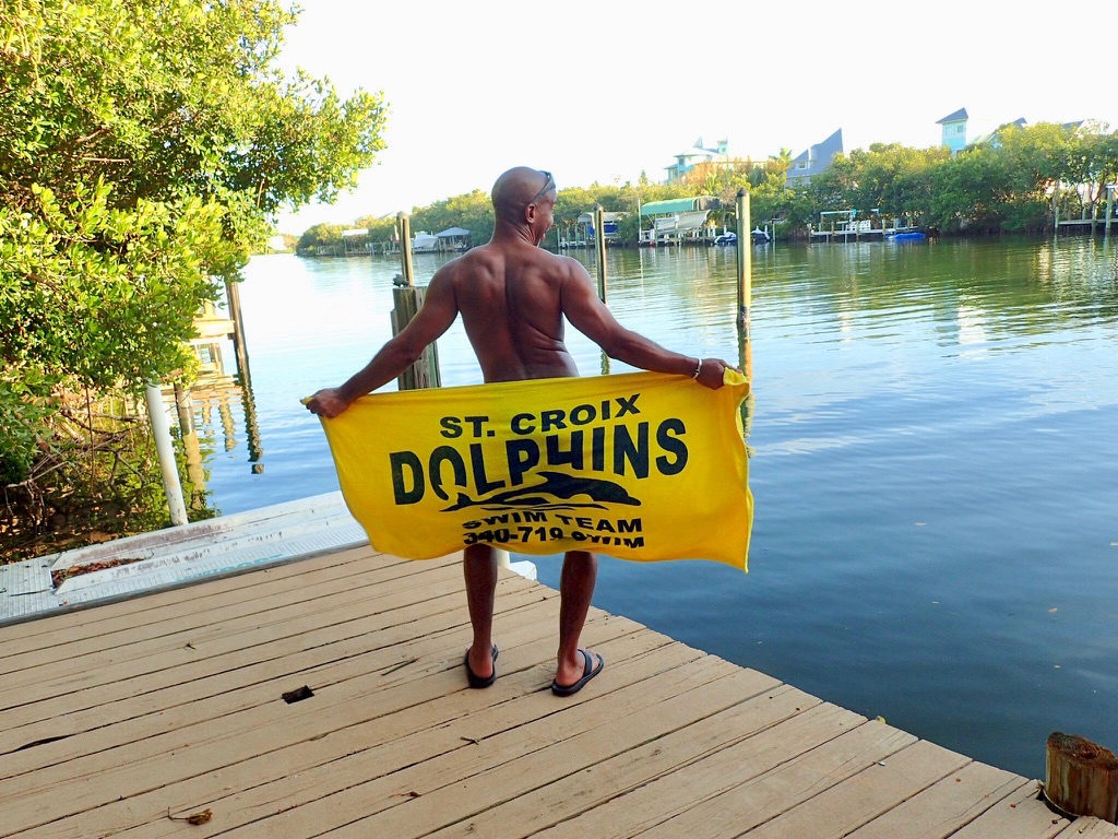 Steve Bennett proudly reps his former swim team, the St. Croix Dolphins. He called his experience competing as a team member all over the Caribbean one of his sources of inspiration for Uncommon Caribbean. (Submitted photo)