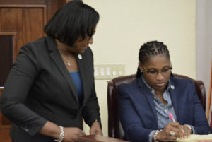 Sens. Donna Frett-Gregory and Janelle Sarauw discuss the VIVIS bill, which they co-sponsored. (Photo by Barry Leerdam, USVI Legislature)