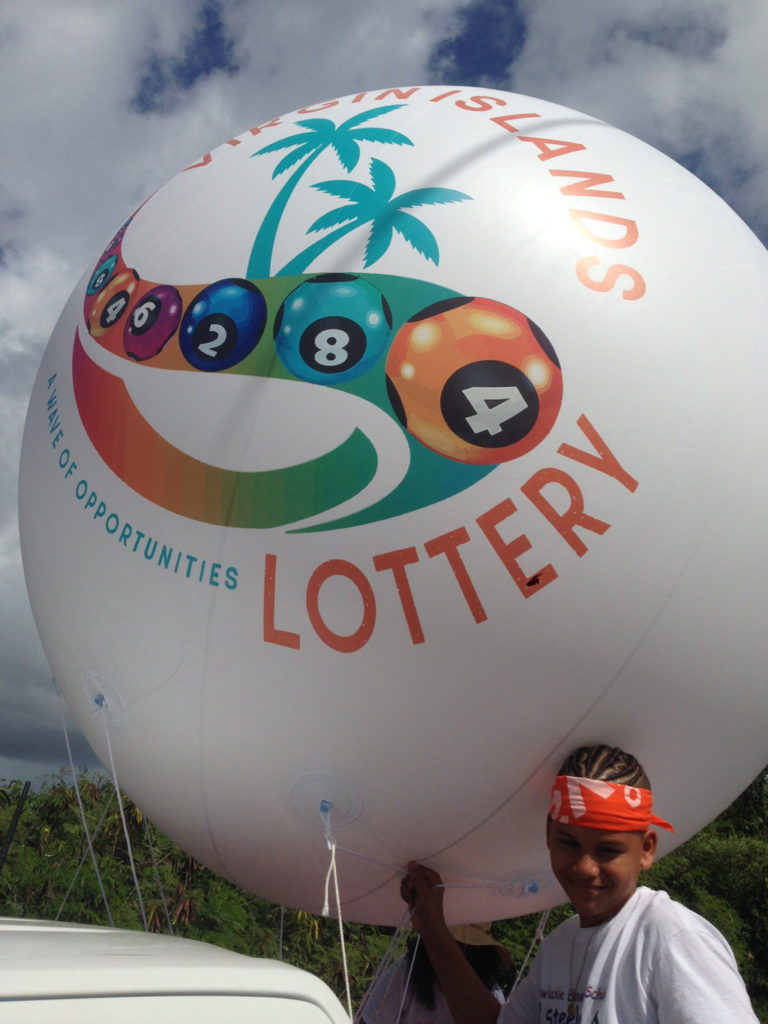 Jadym Arroya’s mother works at the V.I. Lottery, which got him a ride in the parade along with a giant ball. (Source photo by Don Buchanan)