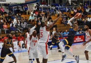 Walter Hodge battles through Cuban defenders to throw up a shot in Monday's game. (Source photo by Kyle Muprhy)