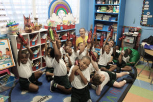 At All Saints Cathedral School Chenese Joseph’s kindergarten class holds their new water bottles aloft. (Source photo by Bethaney Lee)