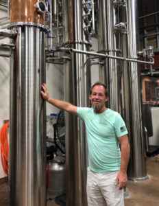 Todd Manley with kettles for making vodka at the Sion Farm Distillery. (Source photo by Susan Ellis)