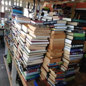 A collection of books before delivery to the Golden Grove Adult Correctional Facility. (Senufa Salley photo)