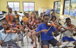 Street Level V.I. founder Priscilla Lynn presents donation to Gifft Hill School on St. John.  From left to right is: music teacher Dennison Blackett, and students Eion Roberts, Christian Foust, Ohsemenard Vales, A.J. Phillips and Ricquan Charlemagne. (Photo provided by Gifft High School)