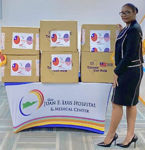 Dyma Williams, interim CEO of the Gov. Juan Luis Hospital, looks over a donation of 20,000 surgical masks from Taiwan. (Photo submitted by JFL Hospital)