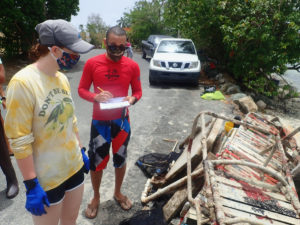 Howard Forbes Jr. and UVI research technician Allie Durdall tally the debris removed from Coki Bay. (Photo submitted by Howard Forbes Jr.)