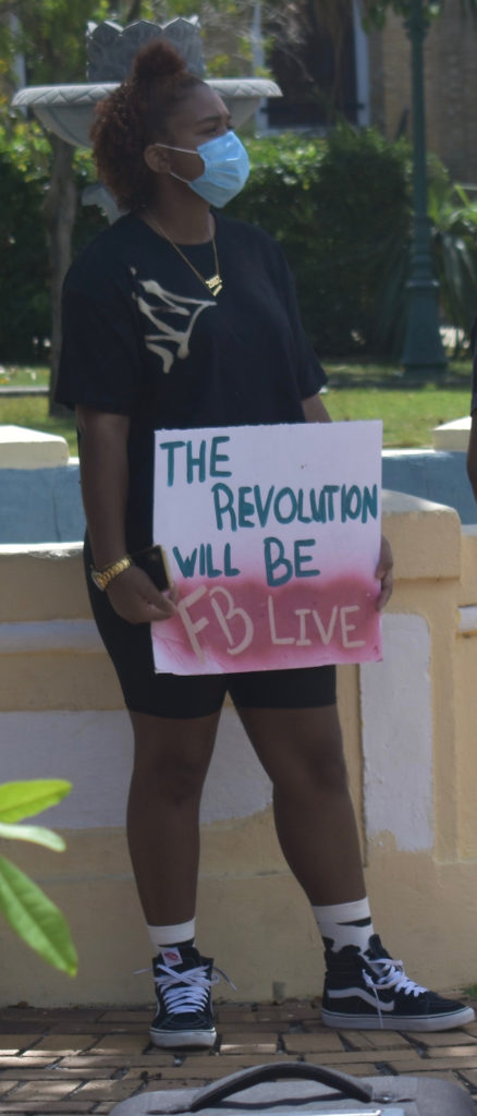 A sign reads “The revolution will be FB Live” a reference to the amount of viral videos about the protest worldwide and a play on the 1960s Black Panther slogan, "The Revolution Will Not Be Televised." (Source photo by Kyle Murphy)