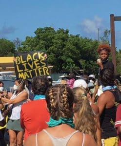 Rally organizer Jalayne Jones addresses the crowd in Cruz Bay Saturday. (Photo by Lisa Etre)