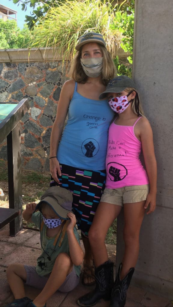 Lauren Magnie and her children Elena, standing, and Otis wear their messages on their shirts. (Source photo by Amy H. Roberts)