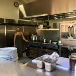 Julie Downard Abdulai steps into he new kitchen at Shaibu’s Garden Oasis.Amy H. Roberts. pg