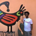 Owners Julie and Shaibu’ pose in front of Sankofa mural. Amy H. Roberts