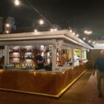 The bar at Shaibu’s is festively lit at night. photo by Amy H. Roberts
