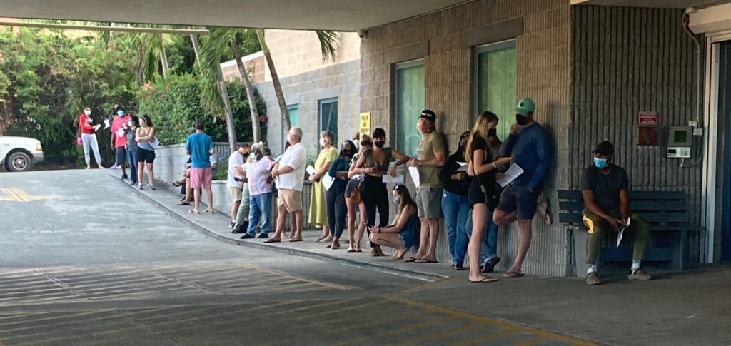 A line forms early Monday morning as people await COVID-19 tests outside the Paragon Building on St. Thomas. (Source photo by Sian Cobb)
