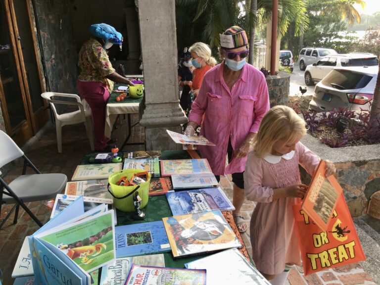 STJ Volunteers Giving Out Children’s Books on Earth Day