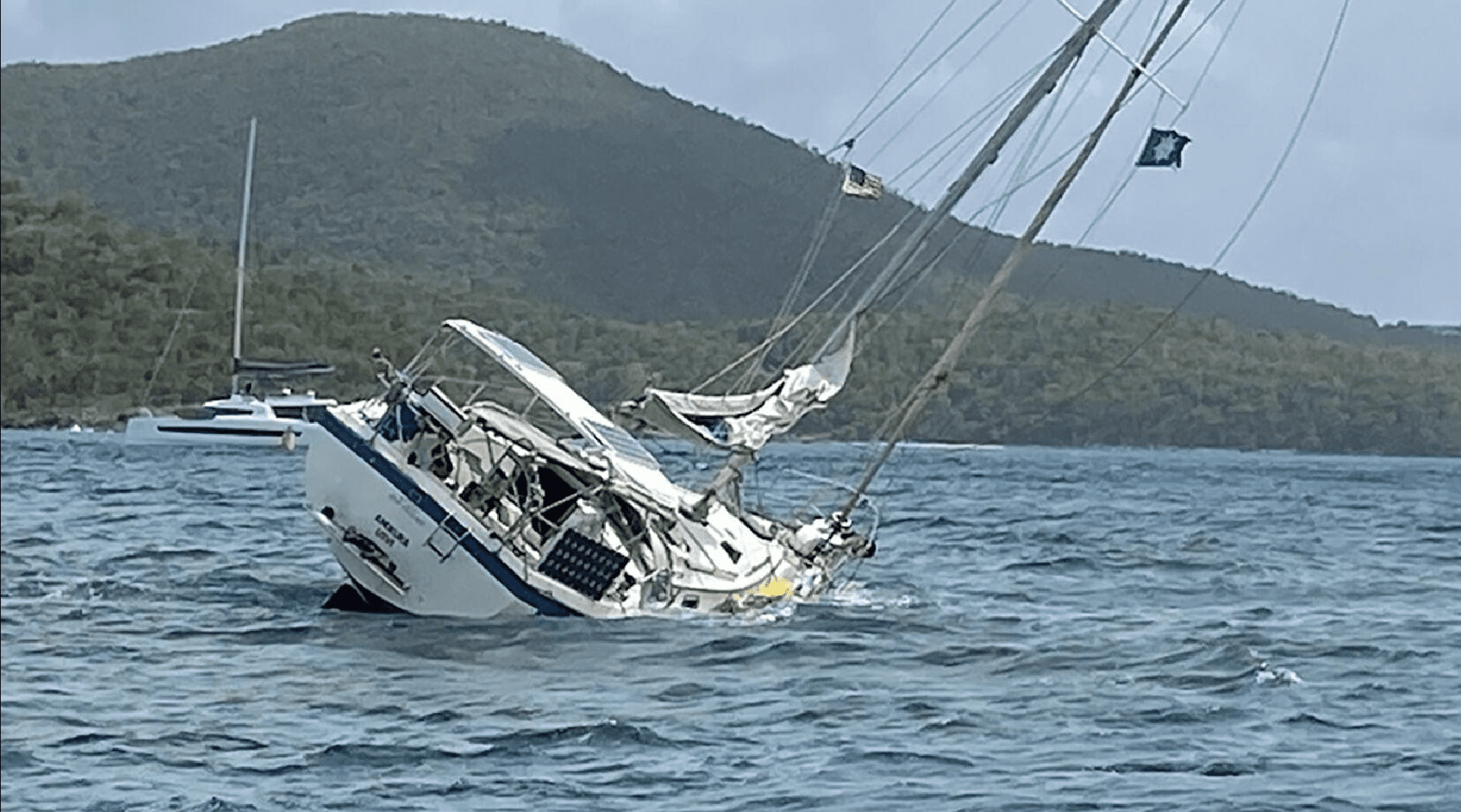 The 42-foot Amokura lists after grounding on July 7 at Johnsonโs Reef off St. John. (Coast Guard photo)