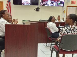 Business owner Ginelle Francis listens to a question posed by PSC Personnel Manager Alicia Gumbs. (Source photo by Judi Shimel)