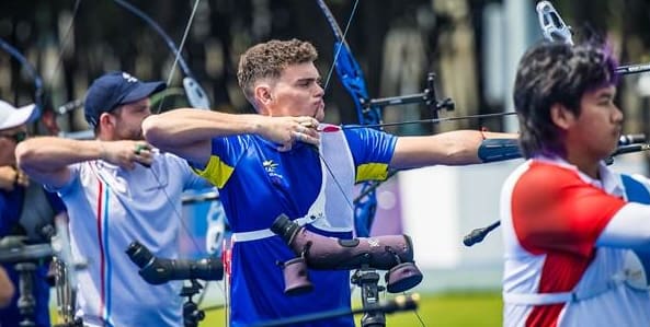 Nicholas D’Amour of St. Thomas, center, practices ahead of the men’s archery individual ranking round Thursday at the Olympic Games in Paris. (Photo by Kevin D’Amour)